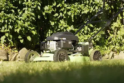LawnMaster mower in front of hedge in Tauranga NZ