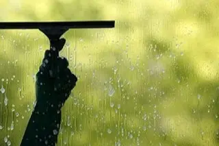 hand squeegee cleaning soapy window in Parkvale